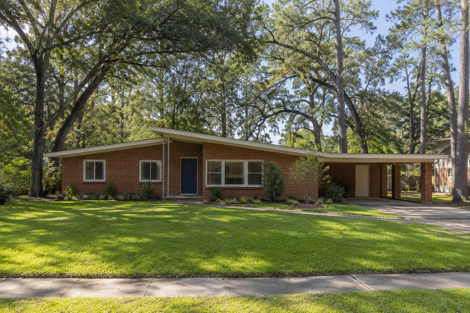 Renovated home with a bright modern exterior and landscaped yard